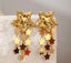 Maxi Aretes dorados de estrellas con diseño colgante