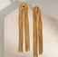 Maxi Aretes largos dorados con nudo